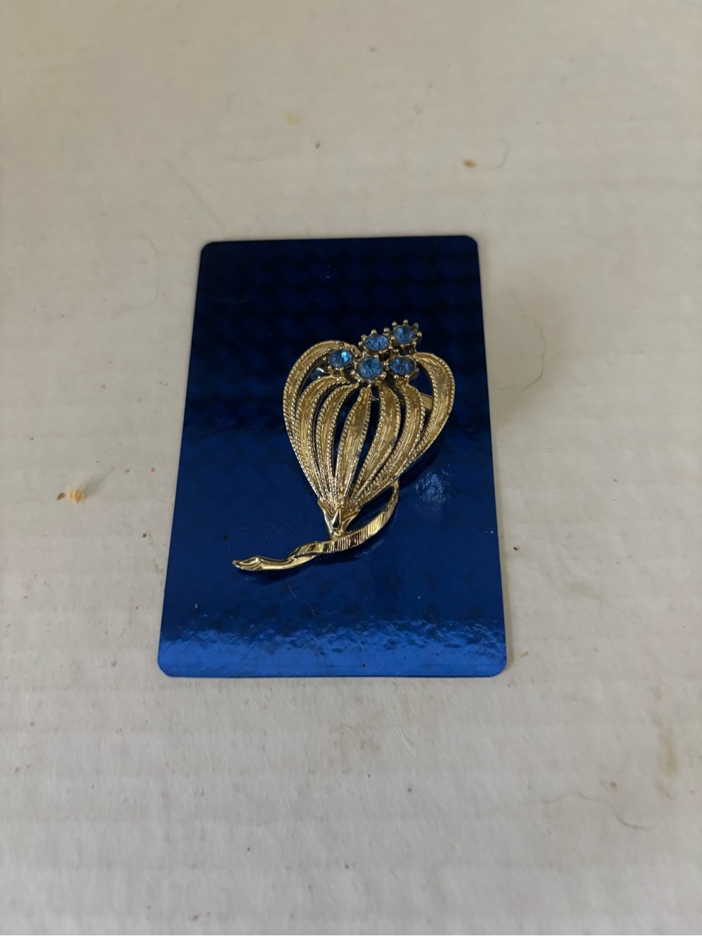 Gold-tone Floral Brooch with Blue Rhinestones